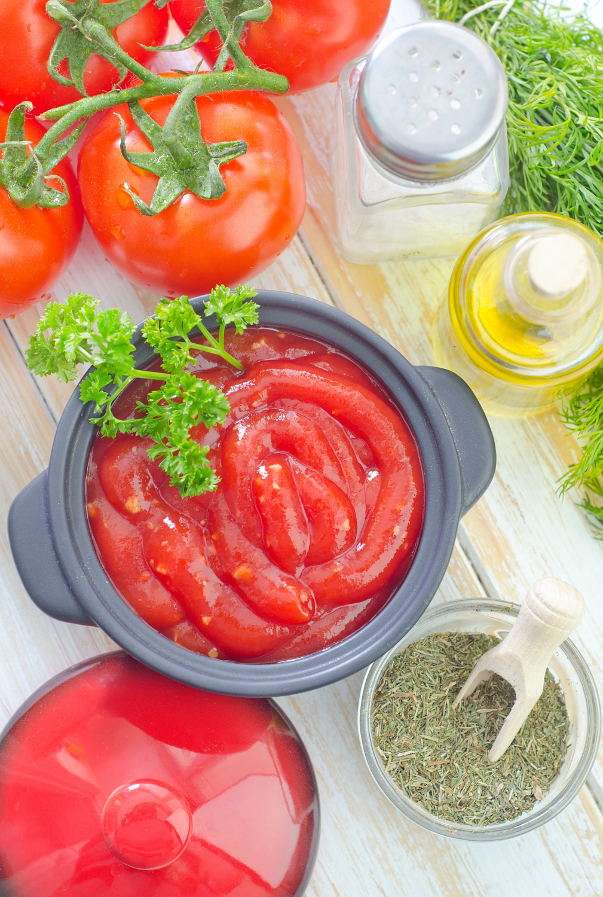 Sos pomidorowy w otoczeniu przypraw, oliwy i pomidorów puzzle